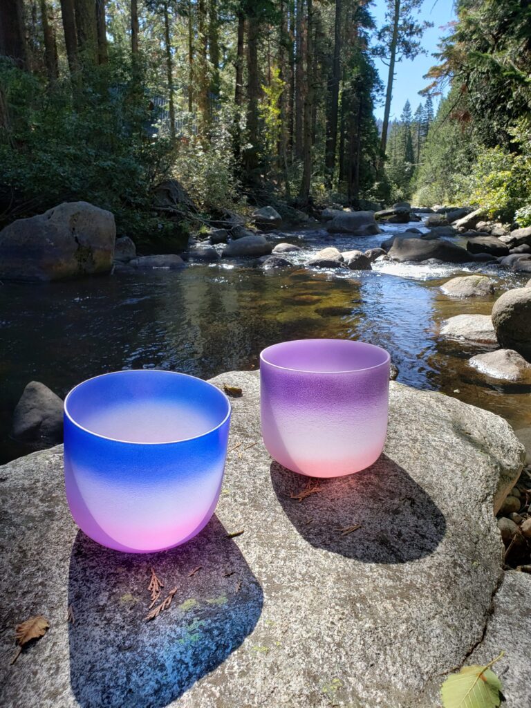 Sound bowls sitting on a rock by the river